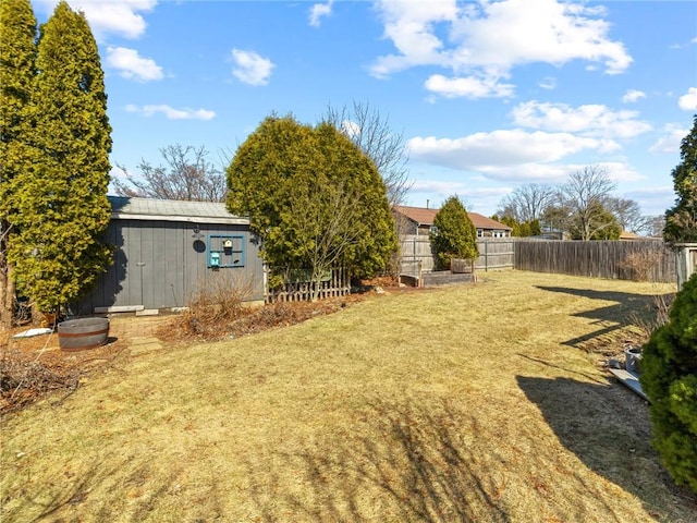 view of yard with an outdoor structure and fence