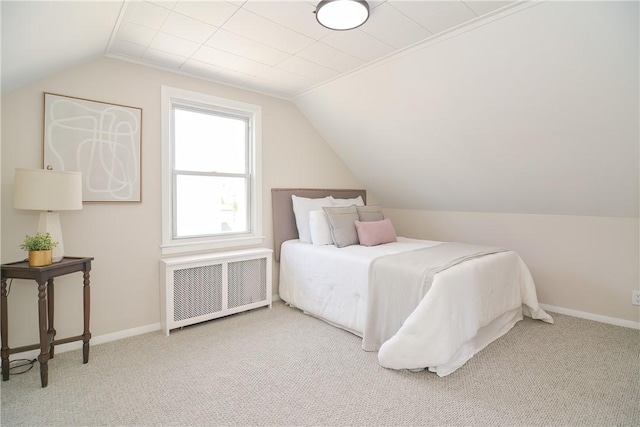 bedroom featuring baseboards, radiator, lofted ceiling, and carpet