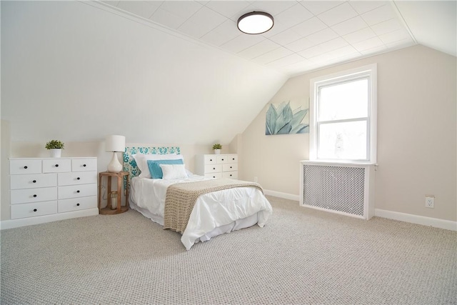 bedroom featuring carpet floors, radiator, baseboards, and vaulted ceiling