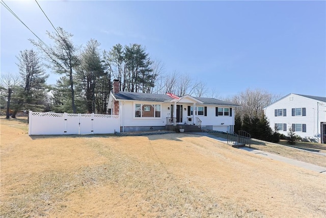 view of front of house with fence and a chimney