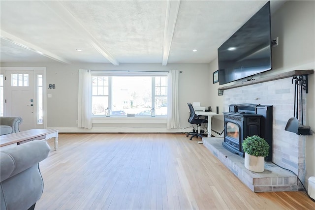 living room with beam ceiling and wood finished floors