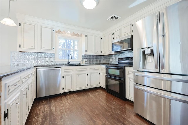 kitchen with decorative backsplash, dark wood-style floors, visible vents, and stainless steel appliances