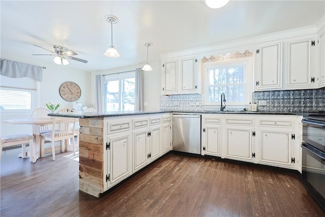 kitchen with decorative backsplash, a peninsula, stainless steel dishwasher, white cabinetry, and dark wood-style flooring