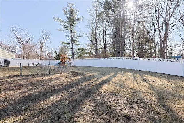 view of yard featuring a fenced backyard and a playground