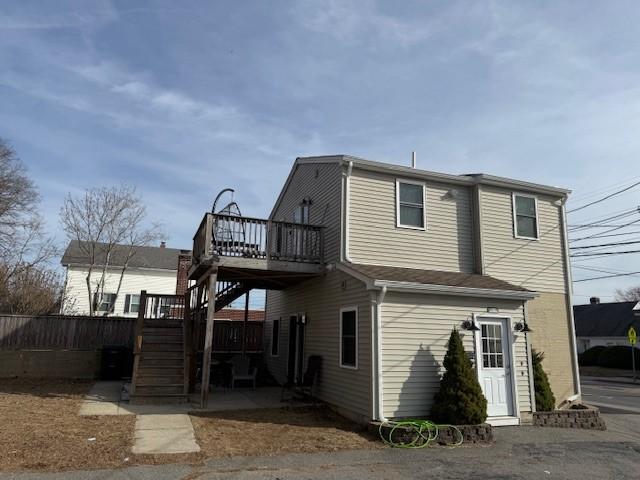 back of property with stairway and a deck