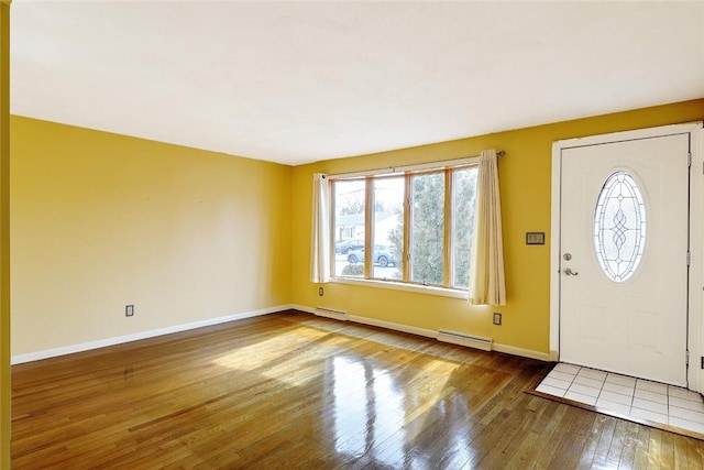 entryway with hardwood / wood-style flooring, baseboards, baseboard heating, and a baseboard radiator