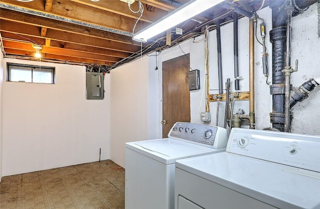 clothes washing area with laundry area, electric panel, independent washer and dryer, and tile patterned floors