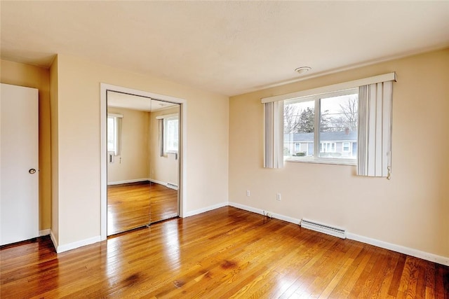 unfurnished room featuring visible vents, baseboards, light wood-style floors, and a healthy amount of sunlight