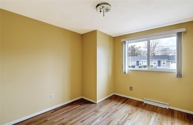 unfurnished room featuring visible vents, baseboards, and light wood finished floors