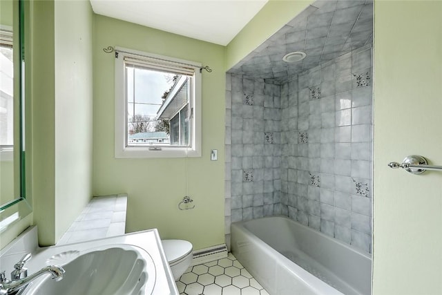 bathroom featuring a sink, baseboards, toilet, shower / tub combination, and a baseboard radiator