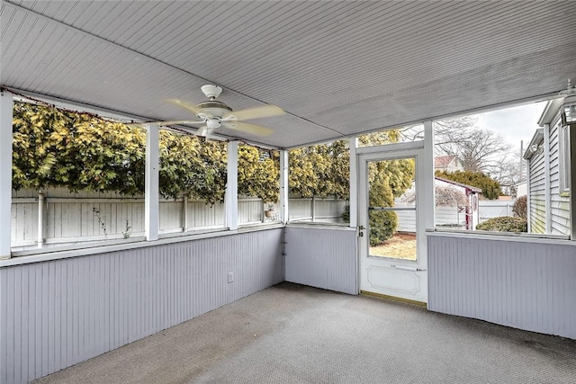 unfurnished sunroom with ceiling fan