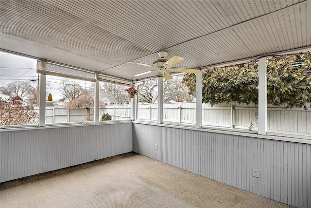 unfurnished sunroom with a ceiling fan