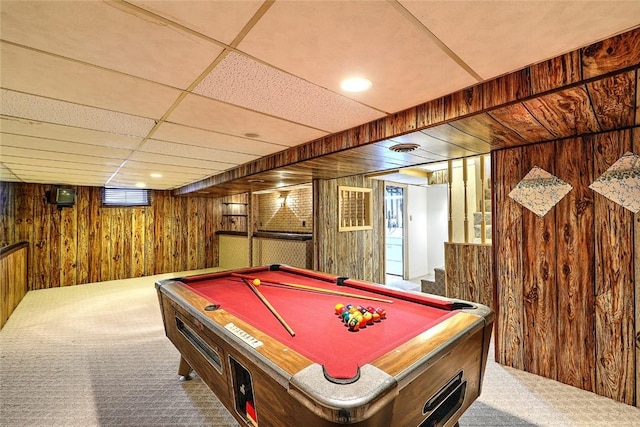 rec room featuring wooden walls, a drop ceiling, billiards, and carpet floors