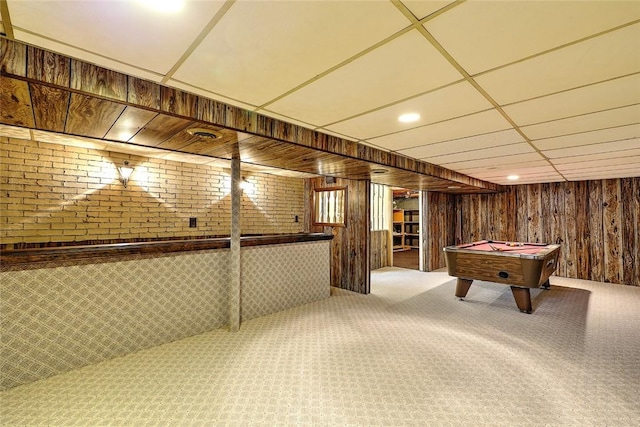 game room with a drop ceiling, billiards, wooden walls, and carpet flooring