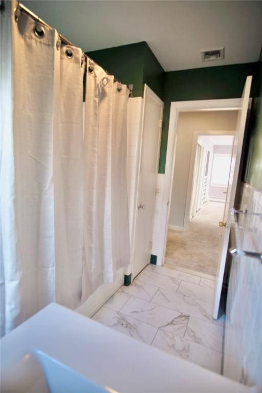 full bathroom featuring curtained shower, visible vents, and marble finish floor