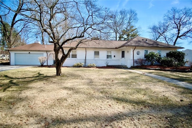 ranch-style home featuring a front lawn, driveway, a chimney, and a garage