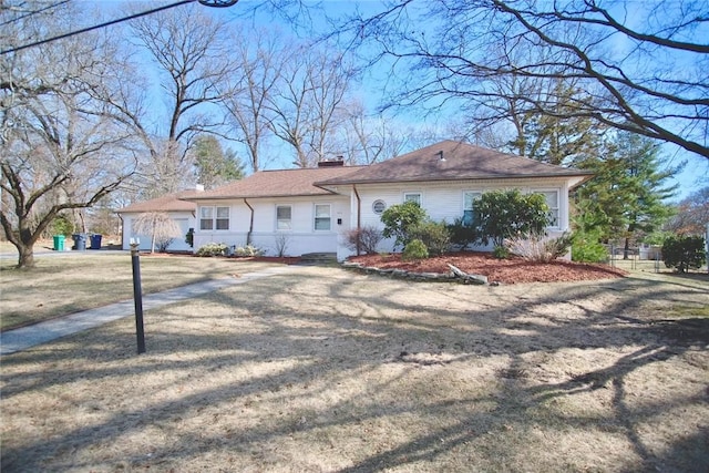 ranch-style home with a chimney