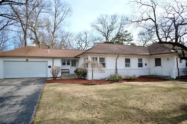 ranch-style house featuring a front yard, driveway, an attached garage, a chimney, and brick siding