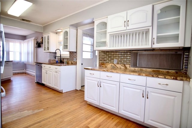 kitchen featuring a sink, backsplash, light wood-style floors, white cabinets, and stainless steel dishwasher