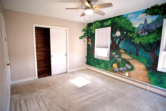 unfurnished bedroom featuring a ceiling fan, baseboards, carpet floors, a closet, and baseboard heating