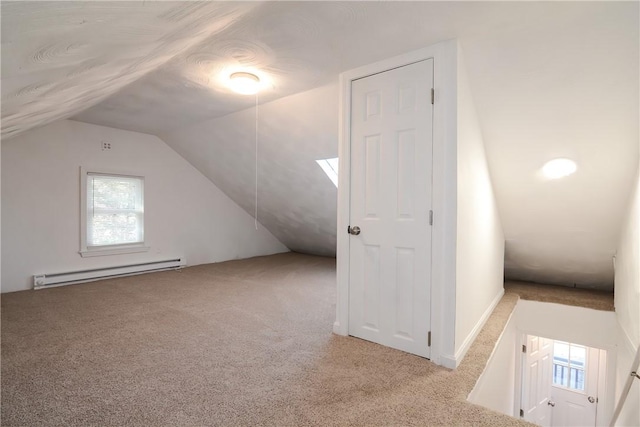 additional living space with vaulted ceiling, carpet, and baseboard heating