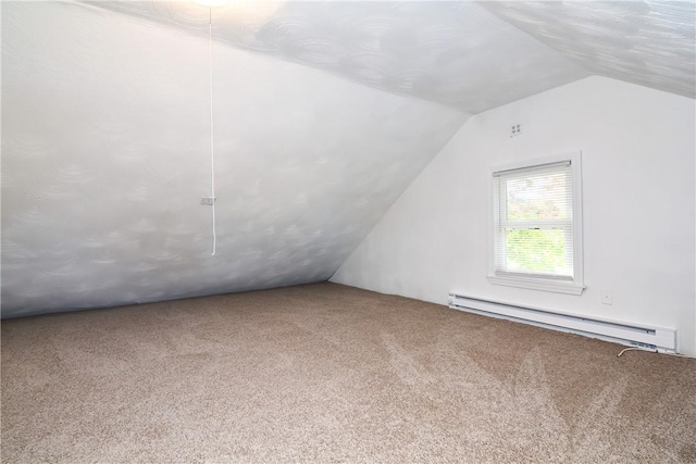 additional living space with a baseboard radiator, lofted ceiling, and carpet flooring