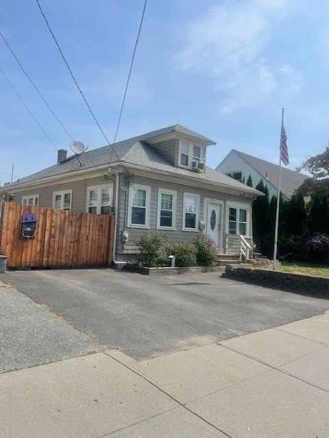 view of front of house featuring fence