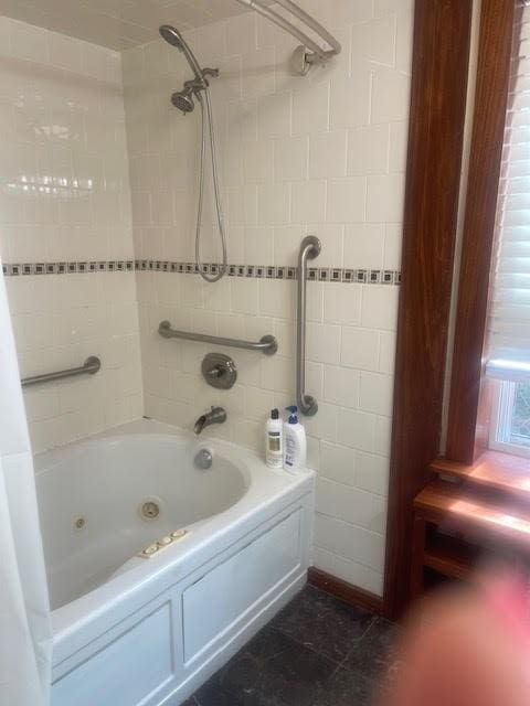 bathroom featuring tile patterned flooring and a combined bath / shower with jetted tub