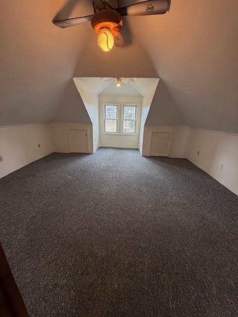 additional living space with a ceiling fan, lofted ceiling, and carpet