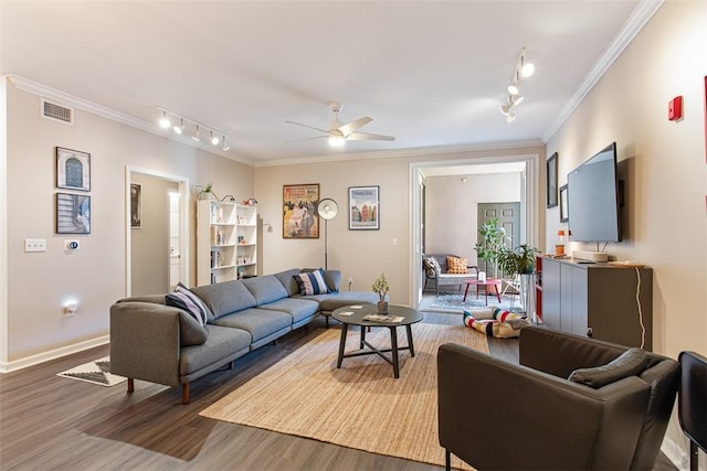 living area with a ceiling fan, wood finished floors, visible vents, rail lighting, and crown molding