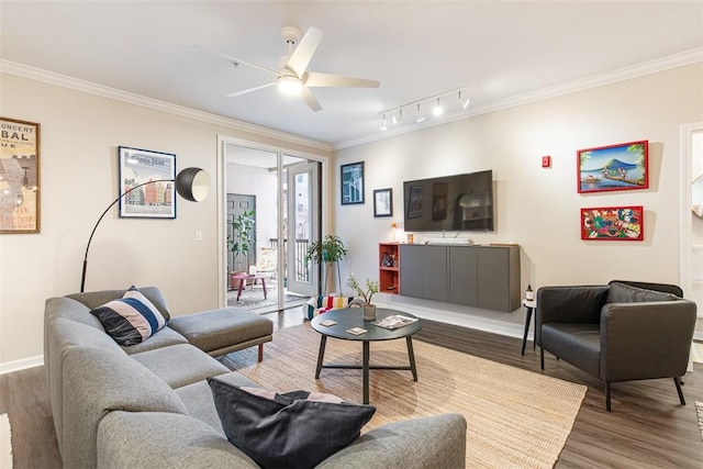 living area with track lighting, baseboards, ornamental molding, wood finished floors, and a ceiling fan