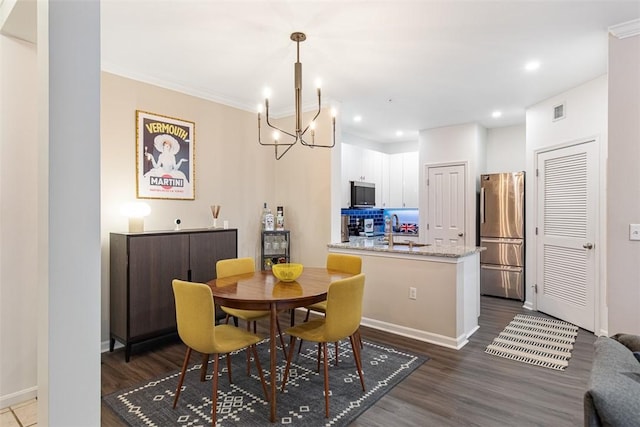 dining room with dark wood finished floors, visible vents, recessed lighting, and an inviting chandelier