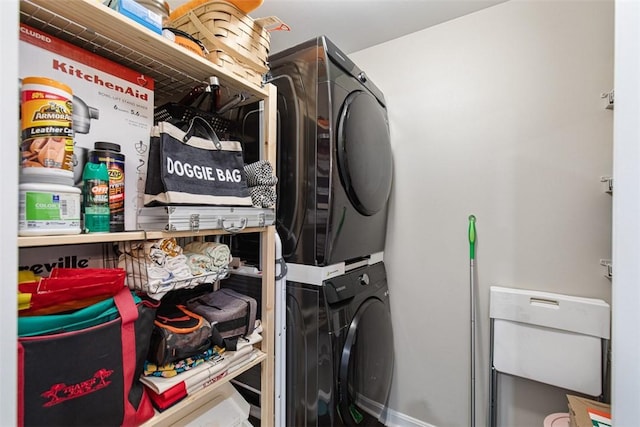 laundry room with laundry area and stacked washer / dryer