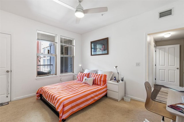 carpeted bedroom featuring visible vents, ceiling fan, and baseboards