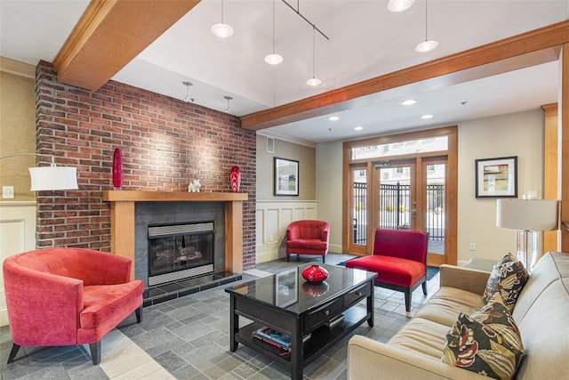 living room featuring recessed lighting, beamed ceiling, stone tile floors, and a tiled fireplace