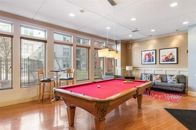 playroom with crown molding, light wood-type flooring, wainscoting, a decorative wall, and billiards