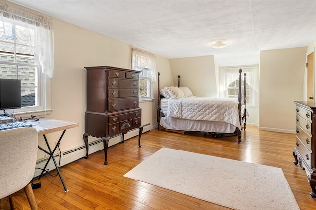 bedroom with light wood-style flooring and baseboards