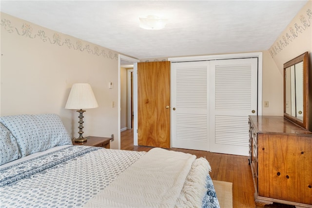 bedroom with a closet and wood finished floors