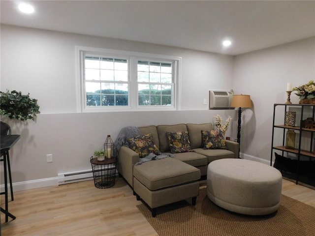 living area featuring a wall unit AC, recessed lighting, light wood-style floors, baseboards, and baseboard heating