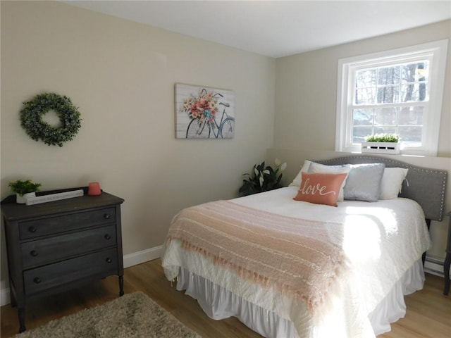 bedroom with baseboards and light wood-type flooring