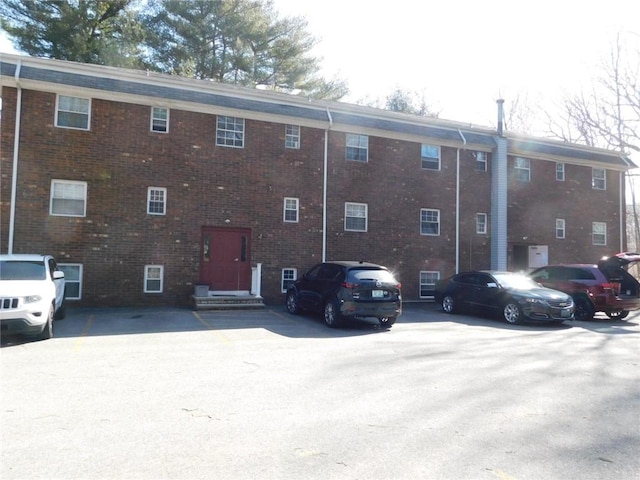 view of property featuring uncovered parking