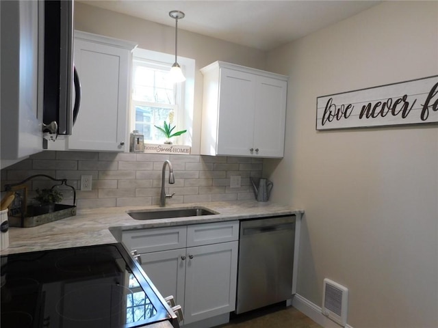 kitchen featuring visible vents, a sink, decorative backsplash, white cabinets, and dishwasher