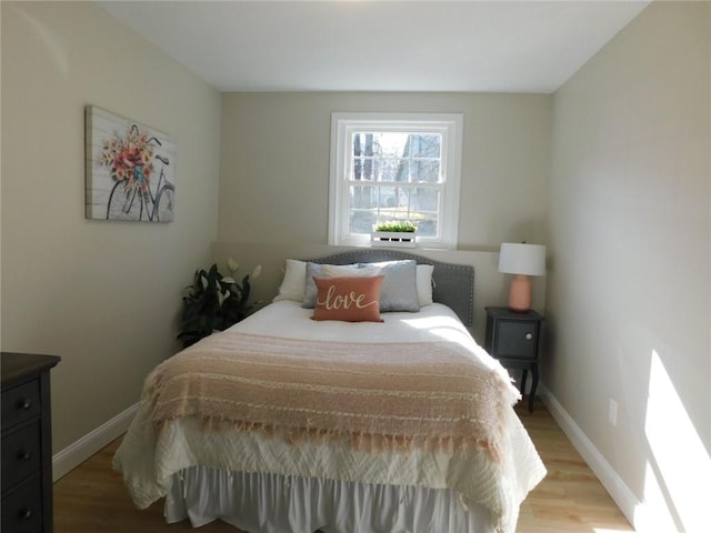 bedroom featuring baseboards and light wood-style floors