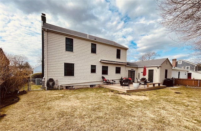 back of property featuring a lawn, fence, and a gate