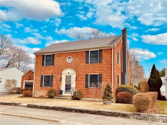 colonial-style house featuring a chimney