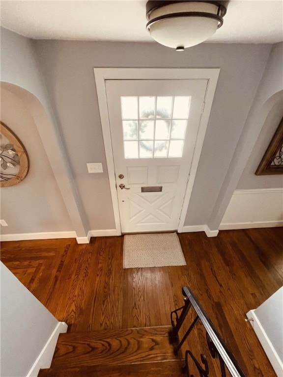 entryway with baseboards and wood finished floors