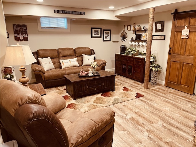 living room with recessed lighting, baseboards, and light wood finished floors