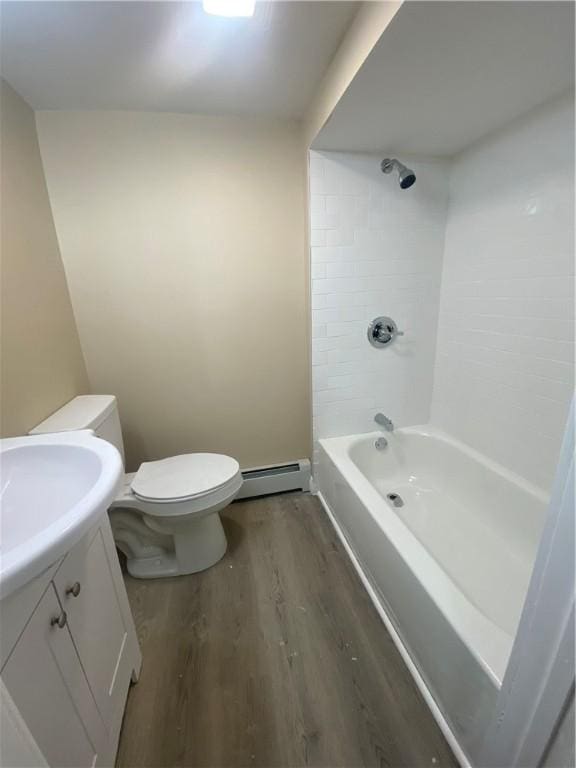 bathroom featuring toilet, wood finished floors,  shower combination, a baseboard radiator, and vanity