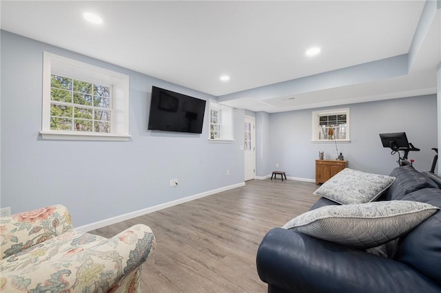 living room featuring recessed lighting, baseboards, and wood finished floors