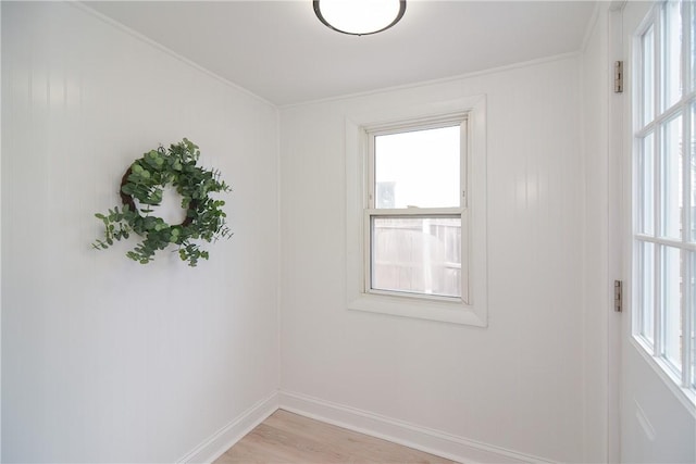 unfurnished room with baseboards and light wood finished floors